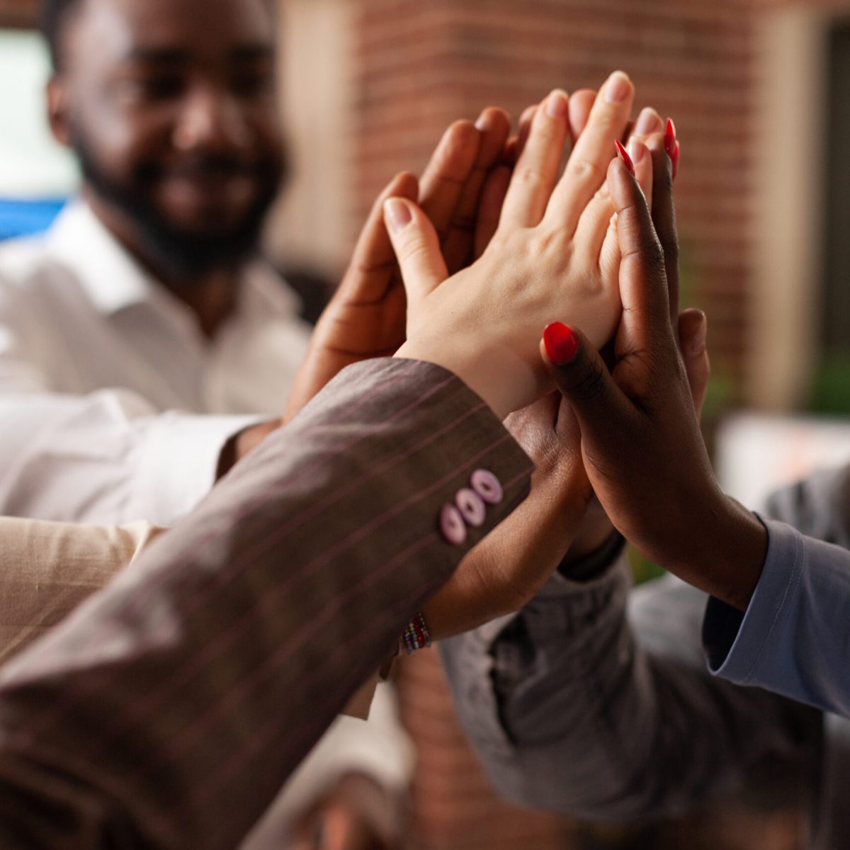 Happy excited businessteam celebrating successful partnership enjoying together in startup office. Diverse smiling businesspeople achievement business collaboration. Concept of victory